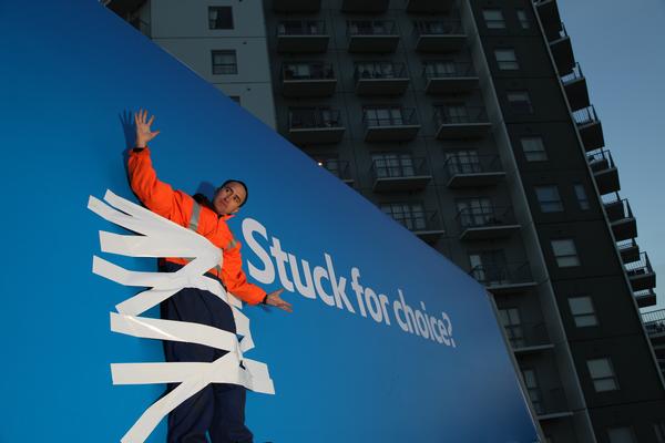 Man stuck to billboard
